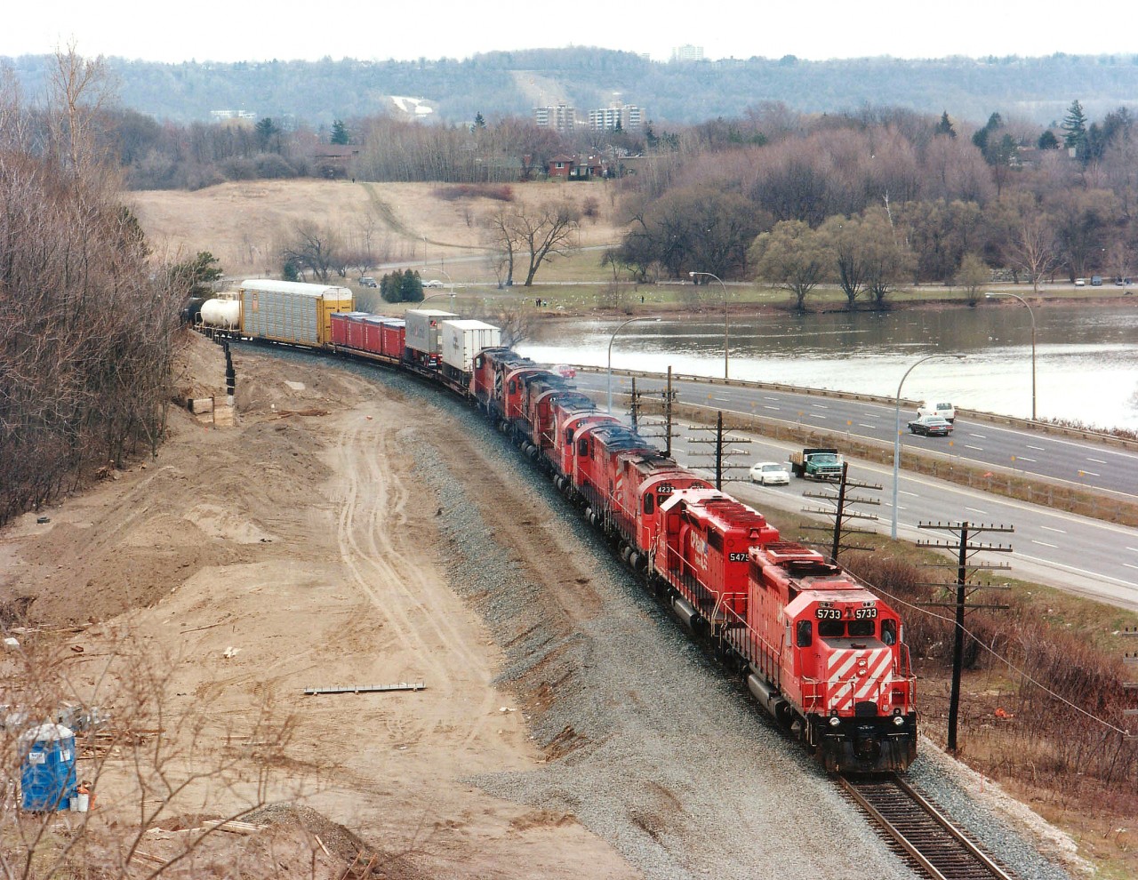 I found myself going into some sort of "railfanner's heat" when this train entered my viewfinder as I stood looking over the High Level bridge at the west end of Hamilton. There had been some interesting lashups as of late but this one was a real treat. CP 5733, 5475, 4237, 4243, 4226, 4718, 4241 and 1621 are seen slowly making their way along. (Hwy 403 is in the background). Certainly a lot of history in these units: 5733 ret'd 2008; 5475 (converted to a "B") went to NRE 2004; 4237 to Delson RR Museum; 4243 to NBEC; 4226 converted to control cab 1104; 4718 "re-retired 1995; 4241 to Que Gatineau; and 1621 was retired in 2011. Note construction for extra track to accommodate GO Transit service for Hamilton is just underway.