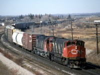 Do you recognize this location ? CN EB 318 taken from the Hopkins street overpass. March 1989. Compare this view to recently posted shots at this location. In the back ground is Victoria street, still a level crossing and the spur track to Superior propane is also viable. To the right of the two class units is what was called a pole line in them days. What a difference 26 years makes. 