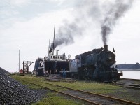 A small group of bystanders has gathered to watch rail cars of coal being unloaded from the car ferry Ashtabula. A common site in the small cottage town on the shores of Lake Erie. Coal arrived from the US to be used at CP facilities across Ontario. The 888 a D10 style locomotive would switch out the loads while the Port Burwell way freight would take the cars north. A lengthy process being that only a dozen cars could be taken at a time to Ostrander where the train would be marshaled together, because of the grades out of Port Burwell.