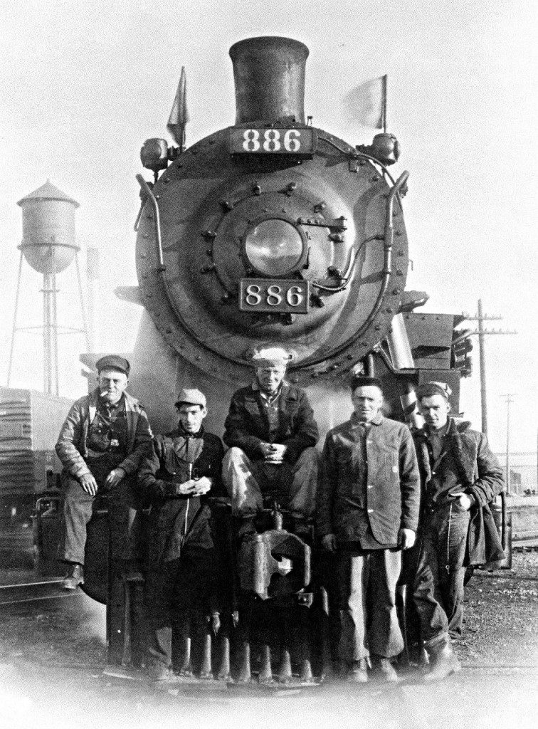 Sitting on the diamond, the crew of CPR extra north 886 have been requested to pose for a photograph.A tradition in the steam era.  From left to right, Engineer Jim Hardy, Firemen Doug Lupson, the Conductor unfortunately who,s name is missing from memory, then brakemen Bill Pegg and Vern Nicholson. Submitted with permission and help from the firemen Doug Lupson.