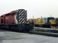 Saturday December 18th 1982. sitting in the lunch room in the Quebec street round house relaxing thinking the shift was over. At 6:45 the shop foreman called. The yard master wants an extra yard  asap, can you service the 5559 and let me know when your finished.  Seen here reversing around the back lead SD40 5559 passes two new ONR GP38-2,s delivered from GMD during the evening before.  The cover over the air intake on 5559 behind the cab was to stop snow from entering and plugging up the baggie filters. This was applied to CP SD40 and dash 2 models.   