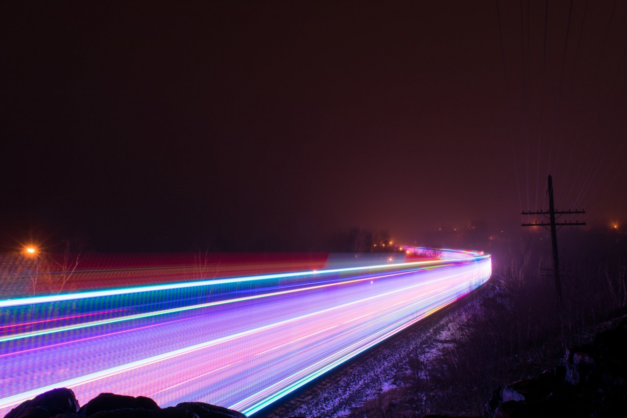 The CP Holiday Train paints the frame with its' lit up consist as it skirts around the shores of Lake Ramsey. I was hoping for a reflection off of the water in the distance but the heavy fog wanted nothing to do with that.