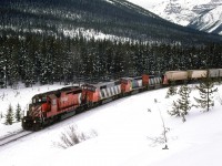 There is a good reason that a CN train is running through Kicking Horse Pass. Their mainline at Hinton is out of service due to the horrific VIA and CN collision. I wasn't in the mountains to catch these detours. I just happened upon this one. We chased it back to Banff, where it became too dark to photograph. Someone would get a photo of this train in one of the popular railfan publications of the time. I did not see them, however.
Note thare was a Cowled unit and the (or one of the) Expo '86 SD-40's in the CN consist. At the time, a pilot engine from the host RR was necessary. 