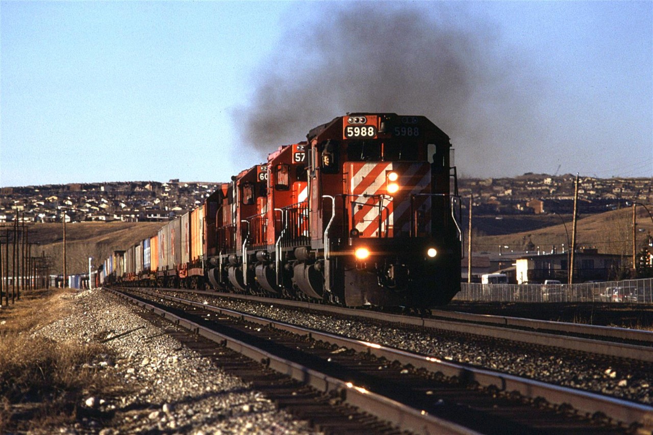 At 1700hrs, this eastbound COFC/TOFC/Auto rack train came through Brickburn. The exhaust suggests that there is some effort being exerted to crest the little rise at this point.