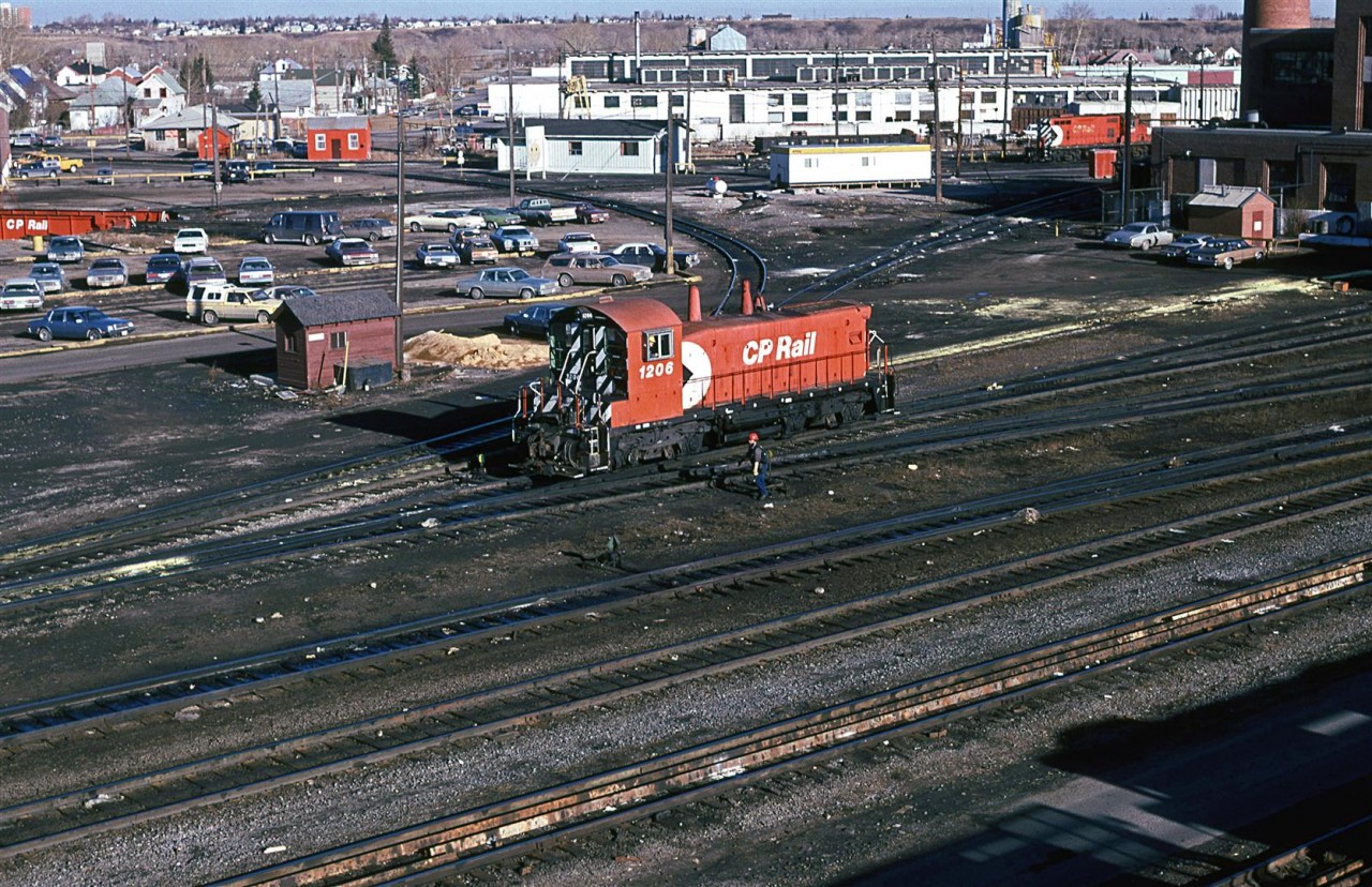 There is not much remarkable about this photograph. Swithers were becoming rare in Calgary about this time, though. The turntable may be seen in the extreme upper left. The wye is above the locomotive....many outbuildings.....dated autos. This view today is positively sterile.