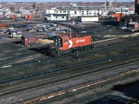 There is not much remarkable about this photograph. Swithers were becoming rare in Calgary about this time, though. The turntable may be seen in the extreme upper left. The wye is above the locomotive....many outbuildings.....dated autos. This view today is positively sterile.

