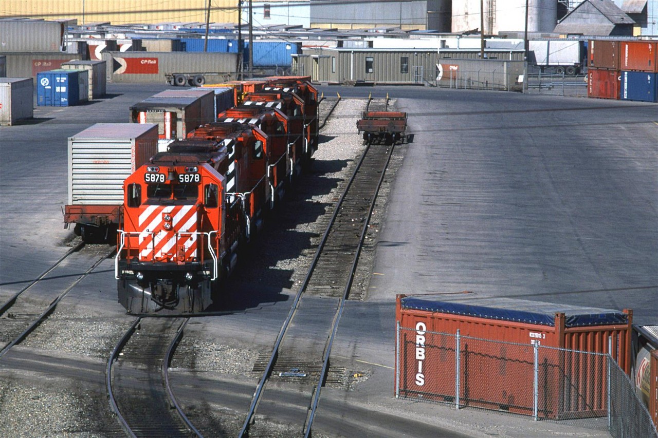 This was CP's intermodal yard in Calgary in 1986. The photo was taken from the north side of the Blackfoot Trail bridge. I am not sure what is there not. Streets View shows a lot of vehicles parked there.