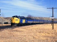 The westbound "Canadian" is near the west switch for Mitford siding, exactly 28 RR miles from downtown Calgary.
I do not know what the structure in the background was - maybe associated with the coal mines or related to a ranch.