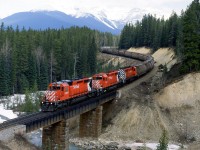 The westbound potash train glides by the much-photographed curve just east of Ottertail siding.
In more recent pictures, I see that an ugly new pole line was installed adjacent to the tracks.