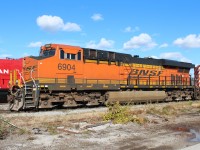 This is a six wheeled locomotive that is equipped with only 4 traction motors giving it an A1A-A1A truck arrangement.There is an air cylinder and linkage on each center axle that along with a variable traction control system in the computer that adjusts the pressure in the cylinders (this varies the weight on the drive axles)to maintain adhesion during changes in grade or wheel slip.