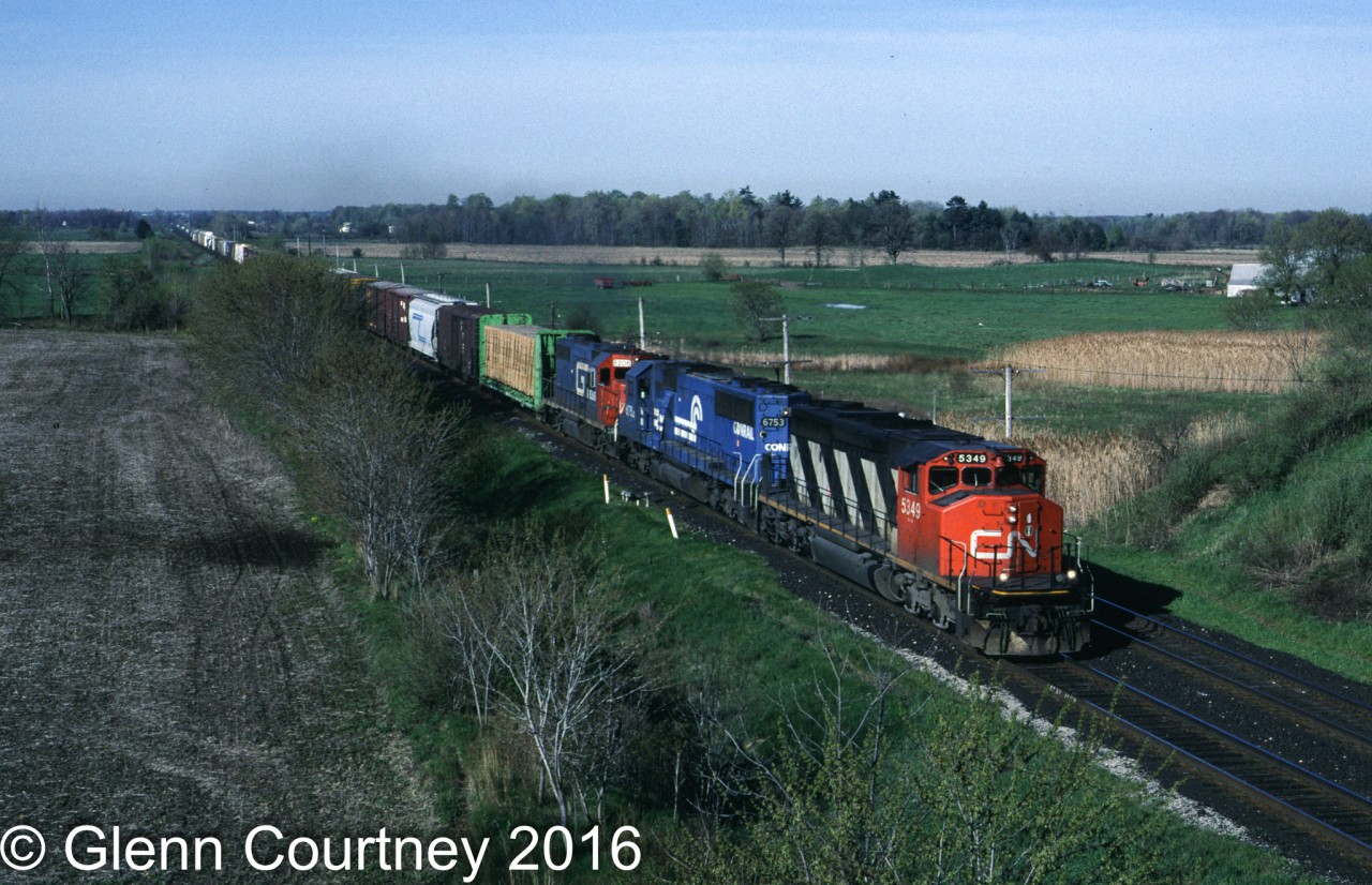 CN SD40-2W 5349 leads train #390 under Governor's Road approaching Lynden, Ontario. Trailing units are  Conrail SD50 6753 and a GTW GP38.