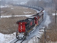 It happened again, this time due to a locked axle on the original leader, which was set off 'somewhere up north' according to the crew. Here as CN 2115 and BCOL 4617 are about of pass under hwy 48 in Mout Albert, they accelerate both after going in for 317 at Zephyr and in deference to the hard slog up the moraine set to begin momentarily. Within two miles they'd be down to about 1mph, exhaust screaming towards the heavens, though muted by the snowfall. Quite a show. 1352hrs.