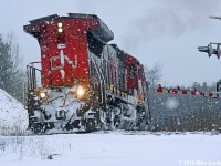 Down to about 1mph, maybe less, CN 2115 leads 318's train to the McCowan Road crossing at mile 38.38 Bala Sub. Sound somewhat muted by the snowfall, the shuddering of the wheelslip control, just letting them slip ever so little, was easier to discern. The hogger was a good sport, who stoically embodied the 'I think I can' spirit of the moment. I took 13 minutes to move roughly 1.2 miles to the Davis Drive overpass, where the pace had noticeably improved. One of those moments that helps you remember why railroading is fascinating... the drama can be quite compelling (and no GEVO's). 1405hrs.