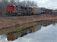 Reflected in still waters outside of Salem, CN 2128 and 2184 lead 306's train down the Kingston Sub. 1527hrs.