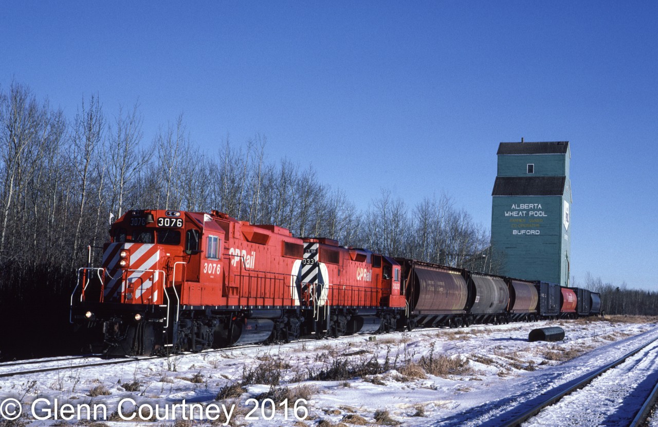 CP Rail's Buford Turn left CP's South Edmonton yard, headed south to Leduc and then went west on the Breton Sub. In this scene it is switching the Alberta Wheat Pool elevator in Buford. I was a little late to get GP9s on this job but a pair of new GP38-2s wasn't so bad. 

Of course the elevator is gone from Buford as is the Breton Sub. On the satellite map I cannot even tell where the elevator was located on this chilly day 29 years ago.