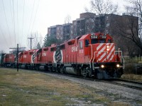 CP's "Moonlight" heads north at Bythia Street through Orangeville, leaving town enroute to Owen Sound on the Owen Sound Sub. Power today are GP38-2's 3132, 3059, 3076 and C424 4250.<br><br>Today, the line to Owen Sound from Orangeville has been abandoned and removed just north of Orangeville, but the line south to Streetsville survives as the Orangeville Brampton Railway.