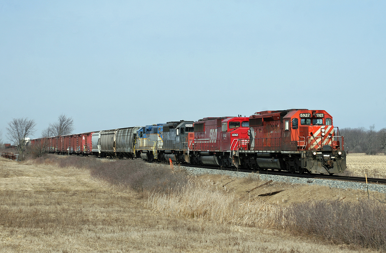 After climbing the Niagara Escarpment, CP 254 cruises through the farmland of the Golden Horseshoe with a colourful consist;  CP 5927, SOO 6062, HLCX 6340, D&H 7304