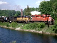 Rolling west past the ponds at Campbellville, CP SD40-2 5935, B&O GP40 3724 and CR GP38 7747 (still in PC black) head west on the Galt Sub towards Guelph Junction in June of 1985.