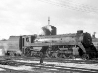 Another view of Canadian Pacific 4-6-4 "Royal Hudson" 2839 in front of the water tower at Lambton Yard in February of 1960, near the end of the steam era, after serving as a pusher on a freight to Orr's Lake. By then, CP had run an "offical" last steam train out of Toronto, but steam did survive for a few months after in remote terminals like Port McNicoll, or as helpers. The cab of MLW S4 7100 is visible to the right, one of a handful of diesel switcher units assigned Lambton Yard for yard switching and local duties. <br><br> Another view of CPR 2839 at Lambton on the same day: <a href="http://www.railpictures.ca/?attachment_id=22158"><b>http://www.railpictures.ca/?attachment_id=22158</b></a><br> CPR 3722 during the last weeks of steam at Port McNicoll ON: <a href="http://www.railpictures.ca/?attachment_id=22492"><b>http://www.railpictures.ca/?attachment_id=22492</b></a><br> Steam mingling with diesel at Galt Station in 1958: <a href="http://www.railpictures.ca/?attachment_id=22003"><b>http://www.railpictures.ca/?attachment_id=22003</b></a>