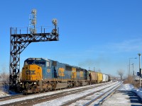 <b>Ex-Conrail and L&N EMD power.</b> SD60I CSXT 8737 (ex-CR 5614) and SD40-2 CSXT 8236 (ex-LN 3608) lead CN 327 underneath the signal gantry near the VIA Dorval Station.