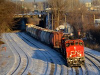 <b>CN 527 into the sun.</b> CN 527 heads west through Montreal West during some nice winter light. Leading is CN 9618, with CN 7275 & CN 7226 out of sight.