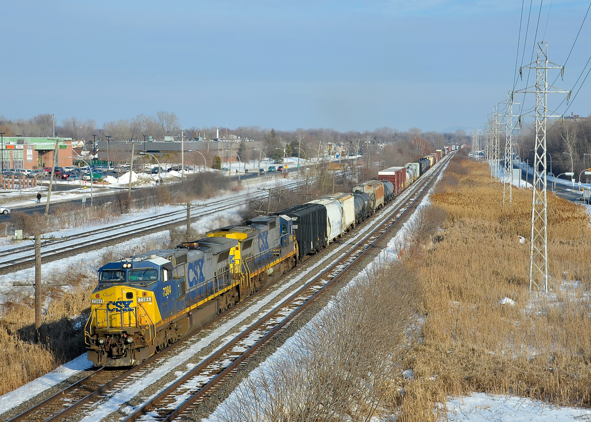 Ex-Conrail Dash8's in matching paint schemes. Ex-Conrail units CSXT 7384 (Dash8-40CW) & CSXT 7495 (Dash8-40C), both in the YN2 paint scheme, lead CN 327 through Pointe-Claire.
