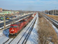 <b>Repainted AC4400CW leading.</b> Repainted AC4400CW CP 9677 is leading two less fresh AC400CW's (CP 8639 & CP 8570) on CP 119, westbound through Pointe-Claire on a sunny afternoon.