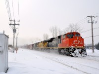 <b>Variety on CN 528.</b> A late CN 528 is approaching the St-Georges crossing in St-Lambert with CN 8928, CN 2021 (still in UP paint at the time) and NS 2570. It will go to Rouses Point, NY where a CP crew will take it south as CP 930.
