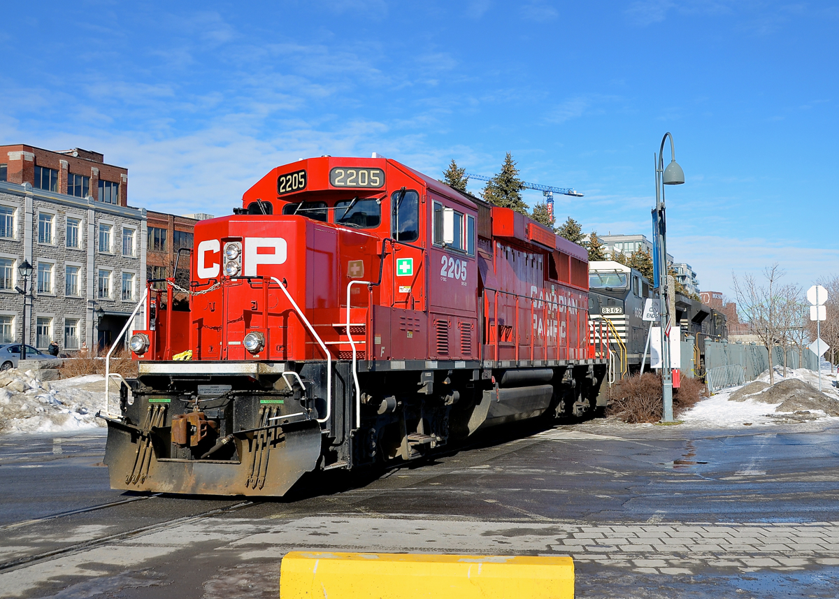 Over the crossing before reversing. CP 142 with an unusual GP20C-ECO leader and two NS units trailing (CP 2205, NS 8362 & NS 2693) is light power in the Port of Montreal after dropping off its train. Soon it will back light on its way back to St-Luc Yard.