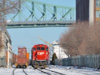 <b>Trains and a ship.</b> CP 142 with an unusual GP20C-ECO leader and two NS units trailing (CP 2205, NS 8362 & NS 2693) is light power in the Port of Montreal after dropping off its train. It is backing up light on its way to St-Luc Yard. At right is a ship berthed in the port.