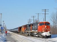 <b>CN 720 crossing over.</b> CN 720 takes off after having stopped at Dorval Station due to congestion up ahead. Power is two CN SD75I's and a BNSF SD70MAC (CN 5733, CN 5793 & BNSF 8867). CN 720 was a crude oil train that ran to Rivière-des-Prairies in Montreal's east end. It has not run since fall 2015 to the best of my knowledge.