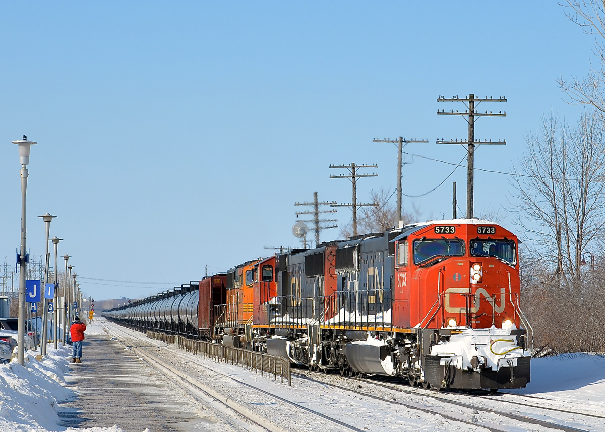 CN 720 crossing over. CN 720 takes off after having stopped at Dorval Station due to congestion up ahead. Power is two CN SD75I's and a BNSF SD70MAC (CN 5733, CN 5793 & BNSF 8867). CN 720 was a crude oil train that ran to Rivière-des-Prairies in Montreal's east end. It has not run since fall 2015 to the best of my knowledge.