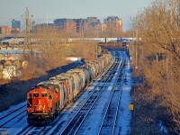 <b>EMD's below and above.</b> In the foreground at ground level, CN 500 with empty grain cars from the Port of Montreal is bound for Taschereau Yard with EMD's CN 7062 & CN 4808 on CN's Montreal sub. Up above on CP's Adirondack sub, AMT 75 is being pushed by an unidentified F59PHI, on its way to its next stop at Lasalle Station.