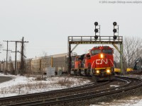 CN 382 leans into a curve as they pass through Paris Junction with CN 2196 leading a trio of EMD locomotives.