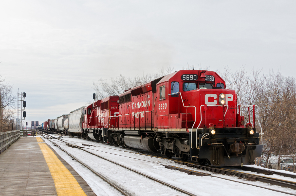 1975 and 2014 vintage EMD's. EMD products with build dates of 1975 and 2014 (SD40-2 CP 5690 & GP20C-ECO CP 2278) lead a long CP 253 (112 cars) through Lasalle Station with most of the train still over the St-Lawrence river and seaway. Of note is that 5690 was declared surplus in 2013 and 'unretired' in 2014.
