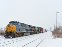 <b>Matching ES44AH's in the snow.</b> A pair of Boxcar logo ES44AH's (CSXT 3144 & CSXT 3002) lead CN 327 through Dorval on a snowy afternoon with 69 cars in tow.