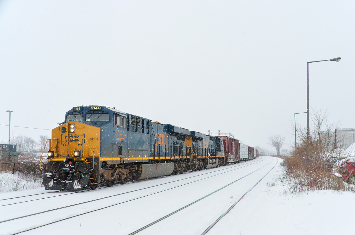 Matching ES44AH's in the snow. A pair of Boxcar logo ES44AH's (CSXT 3144 & CSXT 3002) lead CN 327 through Dorval on a snowy afternoon with 69 cars in tow.