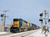 <b>A SpongeBob Squarecab splitting the signals.</b> CN 327 with rebuild SD40-3 CSXT 4070 leading (dubbed 'SpongeBob Squarecabs' by railfans) and CSXT 88 trailing splits the signals on CN's Kingston sub at the Woodland crossing in Beaconsfield. 
