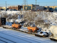 <b>Scale test cars.</b> CN 527 is heading to Taschereau Yard with two Canac scale test cars in tow on a flatcar (CANX 52257 & CANX 52104 on flatcar CANX 61302).