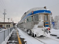 <b>A snowy Park Car.</b> Snow-covered Park Car <i>Evangeline Park</i> brings up the rear of VIA 15, stopped at St-Lambert Station, with 13 more Budd cars ahead. VIA Rail ran extra sections of the Ocean this winter with 100% Budd consists, as it has done the last few winters.