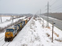 <b>A short CN 327 in the snow.</b> CSXT 5246 & CSXT 551 lead a short CN 327 through Ste-Anne-de-Bellevue. After waiting for two VIA Rail trains to clear, they have crossed over from the north to the south track and are bound for Coteau where they will set off cars.