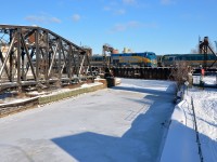 <b>Meet over the canal.</b> VIA 912 pushes a deadhead movement towards Central Station over the Lachine canal as VIA 55 is Toronto-bound on the north track.