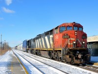 <b>A zebra and a death star.</b> CN 2402 and IC 1020 lead a shorter than usual CN 368 through Dorval on a sunny but very cold morning.