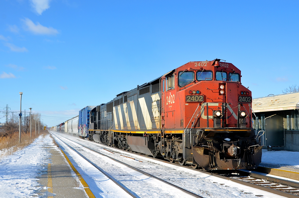 A zebra and a death star. CN 2402 and IC 1020 lead a shorter than usual CN 368 through Dorval on a sunny but very cold morning.