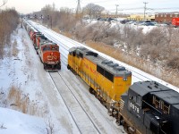 <b>CN/UP EMD meet.</b> A rare for Montreal UP SD60M which has had the UP wings added to its nose (UP 2392, ex-UP 6237) is leading CN 529 as it approaches its terminus of Taschereau Yard. It has just started to pull after waiting for its signal for five minutes or so. Leaving the yard is CN 500 with grain loads for the Port of Montreal, with GP38-2W CN 4802 and a GP9 for power.