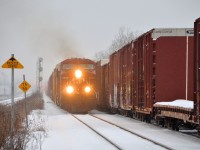 <b>CP 142/143 meet.</b> CP 142 at left is approaching Lachine station with CP 8629 leading as CP 143 departs at right after a lift. CP 142/143 are intermodal trains between Chicago and Montreal, though as seen here, they also carry mixed freight recently.