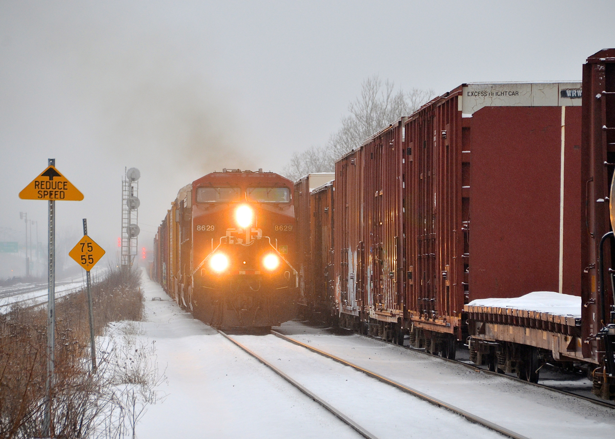 CP 142/143 meet. CP 142 at left is approaching Lachine station with CP 8629 leading as CP 143 departs at right after a lift. CP 142/143 are intermodal trains between Chicago and Montreal, though as seen here, they also carry mixed freight recently.