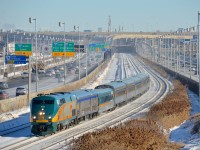 <b>Not quite a matching consist.</b> VIA 63 has a single LRC car marring a 100% stainless steel consist (the same consist it has had for months), as it heads west on CN's Montreal sub. At left and right is highway 20, which unusually runs with the eastbound lanes on the north side for a few miles here.