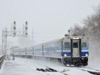 <b>Approaching Lasalle station.</b> AMT 73 is about to stop at Lasalle Station with cab car AMT 708 leading and AMT 1341 pushing during a snowstorm