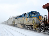 DH 7304 (one of only two lightning striped GP38-2's remaining) is through Lasalle station, trailing CP 8735 on CP 253. Presumably it is going to St-Luc for servicing.